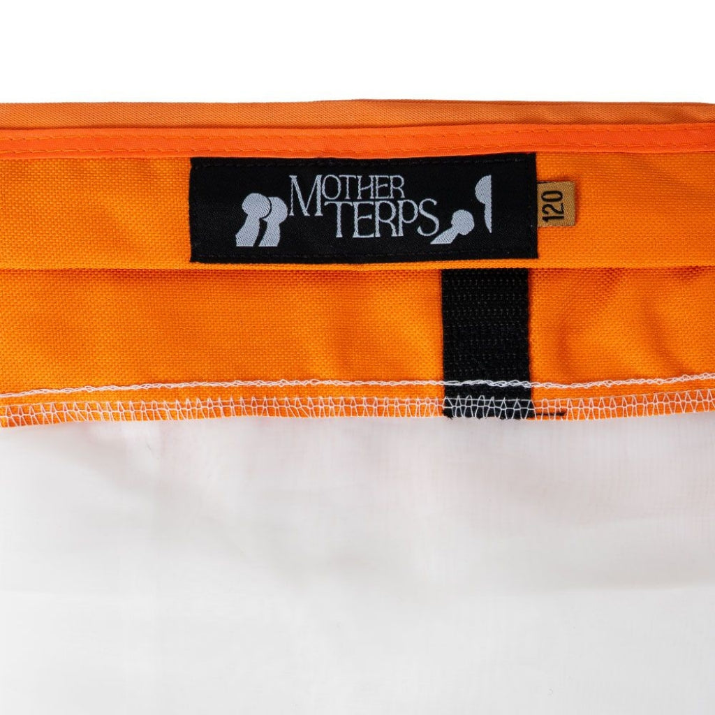 Close-up of an orange mother terps bubble bag with a black brand label reading Mother Terps and a small size tag marked 120, shown against a white background.