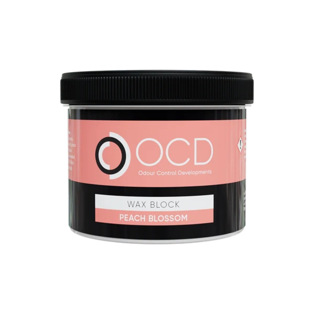 A black plastic jar of OCD Odour Control Developments Wax Block in the scent 'Peach Blossom', featuring a pink and white label on a white background.