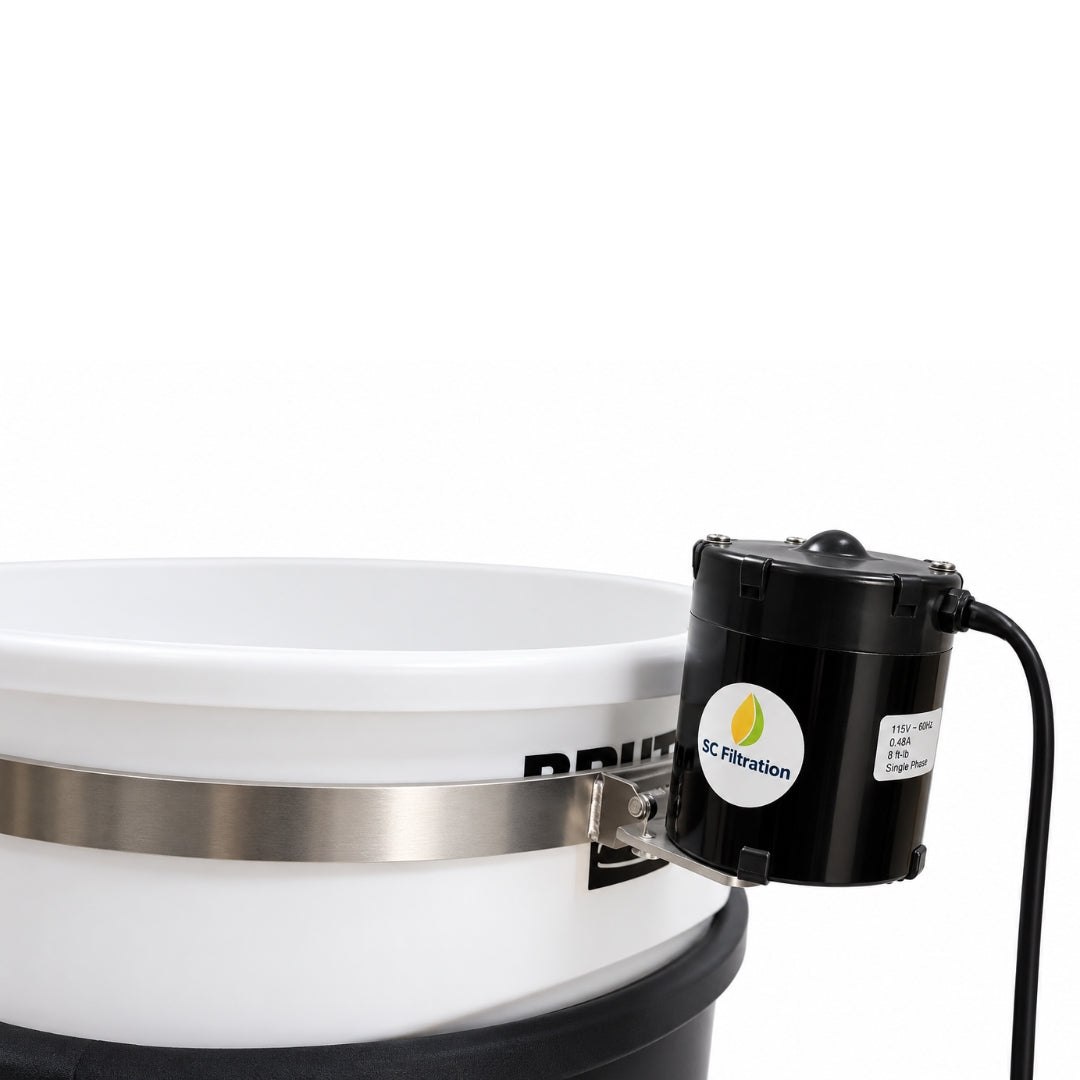 A close-up of a white plastic bucket with a silver metal band, and a black cylindrical motor attached on the side.
