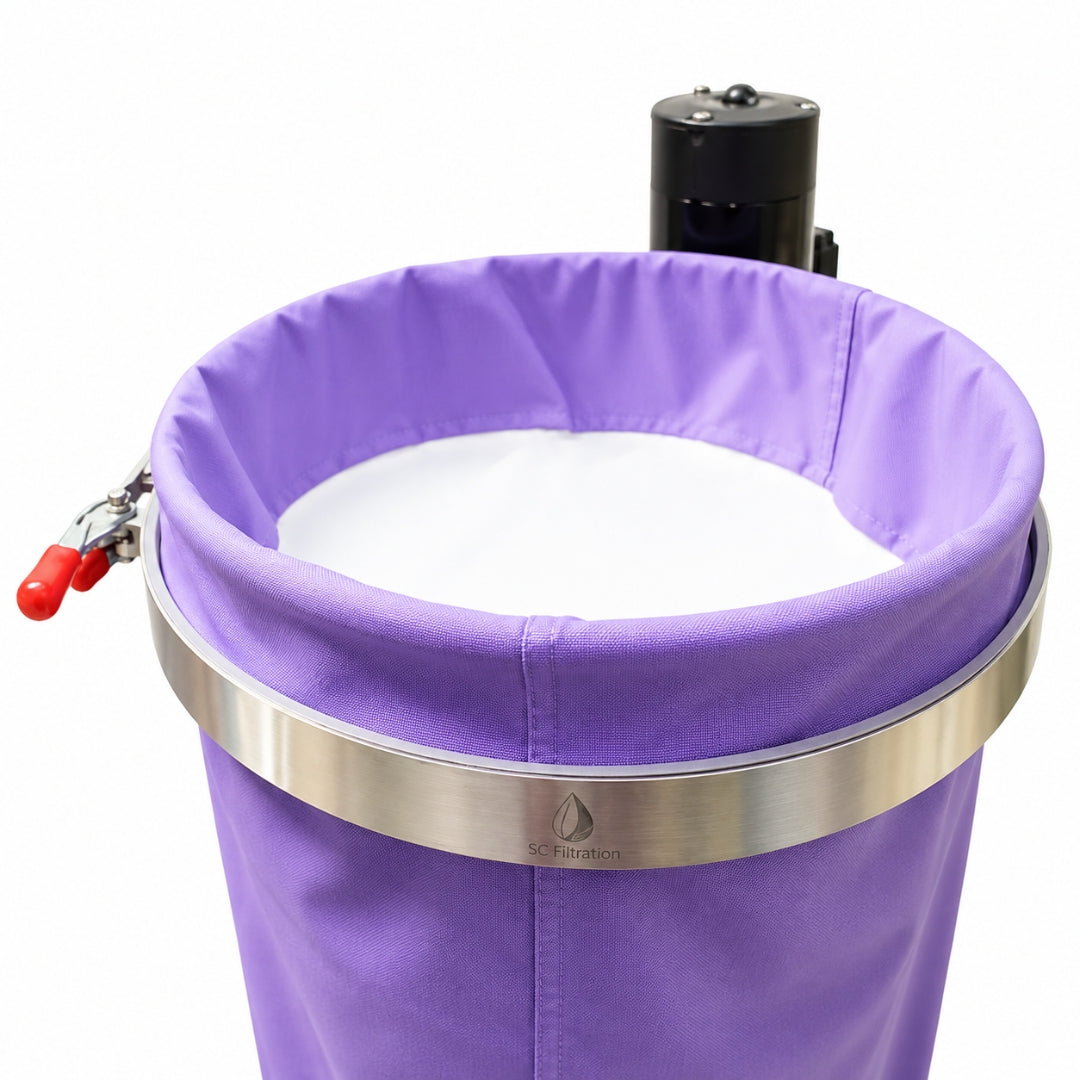 A close-up of a purple fabric filter bag, secured by a silver metal band and a black motor, on a white background.