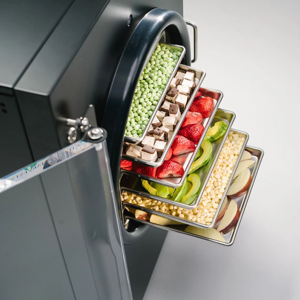 harvestright home freeze dryer Gray machine with compartments filled with various food items on a light grey background