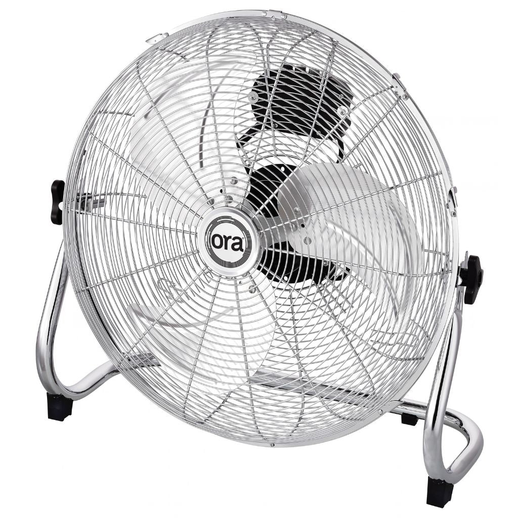 A silver Ora metal floor fan with a wire safety grille, chrome stand, and black accents, featuring the 'ora' brand logo in the center.
