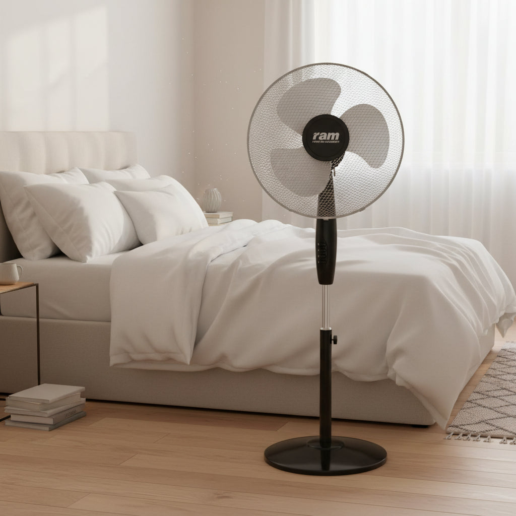 A black Ram pedestal fan with a circular wire mesh guard and three blades, shown against a plain white background.