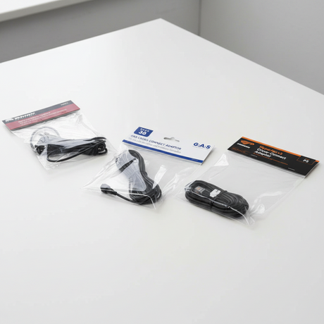 Three packaged black cross-connect cables on a white background: a Rhino Products cross-connect adapter, a Pack 36 gas cross-connect adapter, and a HyperFan v2 gas cross-connect adapter.