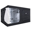 A black GorillaBox Deluxe grow tent measuring 4m-3m-2m with a reflective silver interior, shown with the front door partially open. The tent features a zippered side pocket with a small gorilla logo patch and ventilation holes on the side.