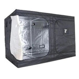 A black GorillaBox Deluxe grow tent measuring 5m-4m-2.2m with a reflective silver interior lining, shown partially open with a door panel pulled out on the left. The tent features a zippered door and a small gorilla logo patch on the front.