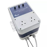 A Senscom Hybrid Controller 8 Ampere electrical device with a white and navy blue casing, featuring two UK three-pin wall outlets on the front, three rotary control knobs, and two gray cables coming out of the bottom, shown on a white background.