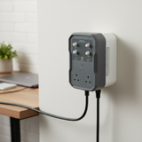 A wall-mounted Mission Control DigiStep Temperature Controller with two UK-style wall outlets and four control knobs, shown plugged into a wall in a home office setting.