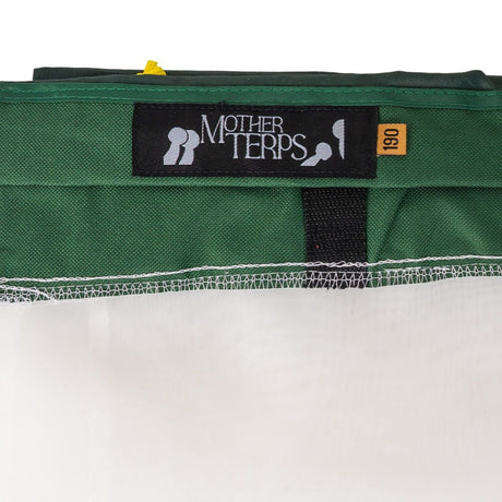 Close-up of a green Mother Terps Bubble bag, showing a black woven label that reads 'MOTHER TERPS' and a small orange tag marked '190'.