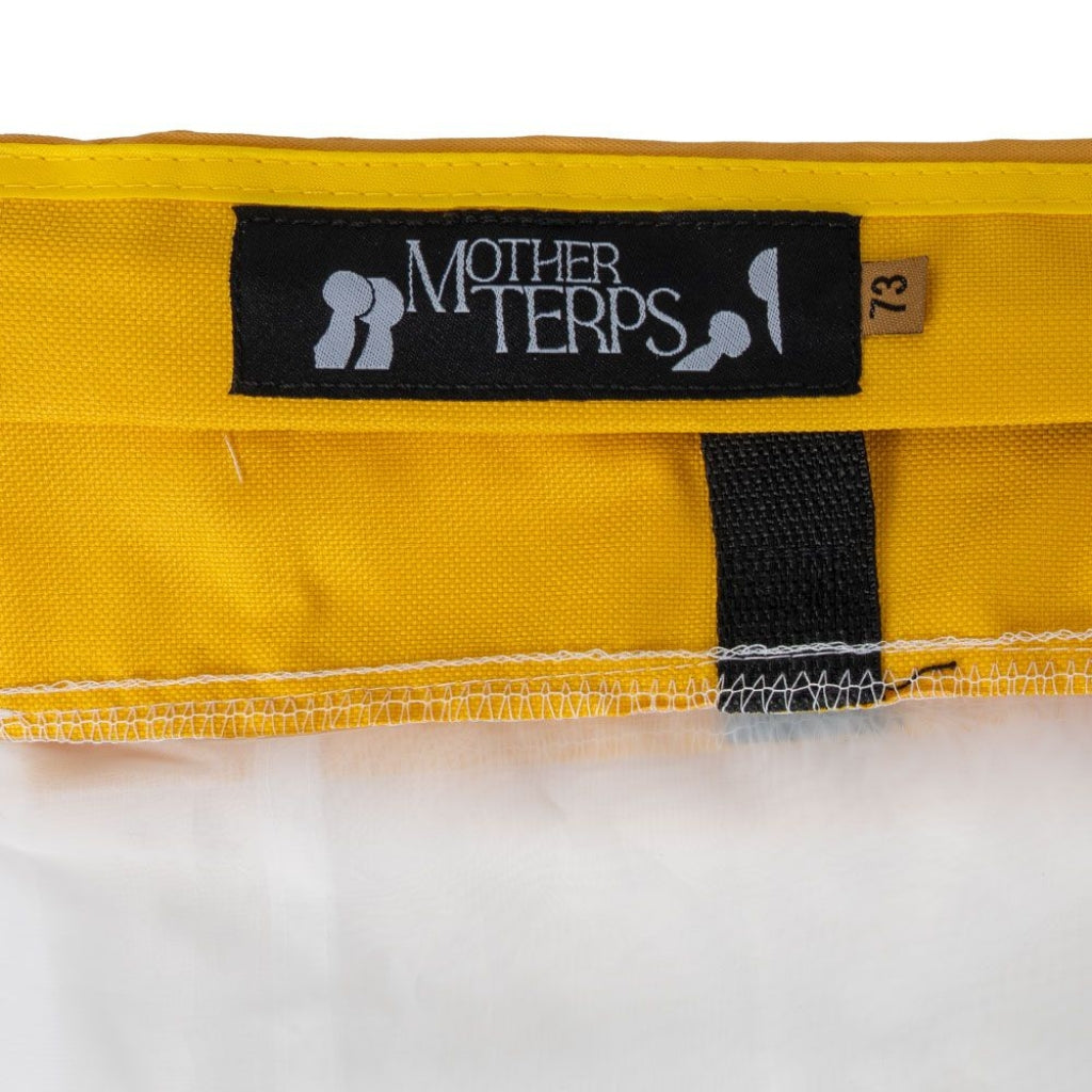 Close-up of a yellow Mother Terps Bubble Bag with a black Mother Terps brand label and a small size tag reading 73, shown against a white background.