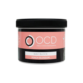 A black plastic jar of OCD Odour Control Developments Wax Block in the scent 'Peach Blossom', featuring a pink and white label on a white background.
