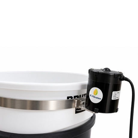 A close-up of a white plastic bucket with a silver metal band, and a black cylindrical motor attached on the side.