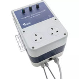 SMS2COM Hybrid Controller 4 Ampere power adapter with dual UK wall outlets, two black rotary knobs, and two gray cable connectors, shown on a white background.