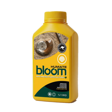 A yellow bottle of Humate Bloom Advanced Floriculture organic humus fertilizer, featuring a label with a shell graphic, on a solid white background.