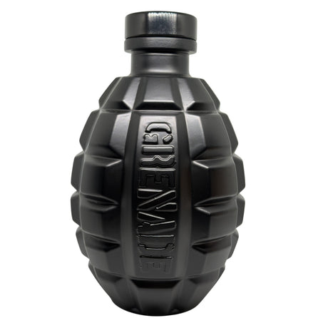 A matte black bottle shaped like a hand grenade, featuring a ribbed body and the word 'GRENADE' embossed vertically on the front, set against a plain white background.