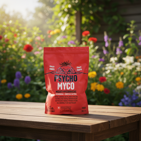 Red 'Psycho Myco' package on a wooden table with a garden background