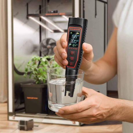 Person using a Spider Farmer digital water quality meter to test water in a glass.